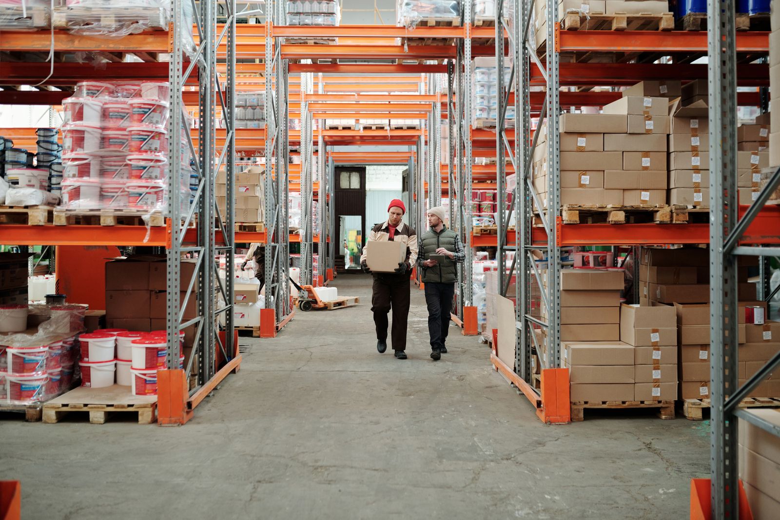 A warehouse aisle, pallets racked to the ceiling