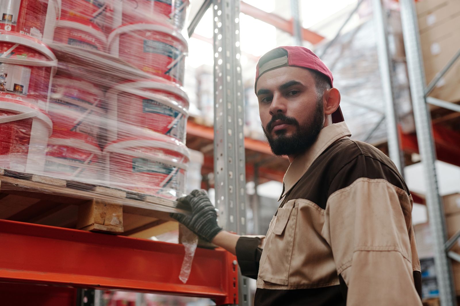 A worker picking stock in a warehouse aisle