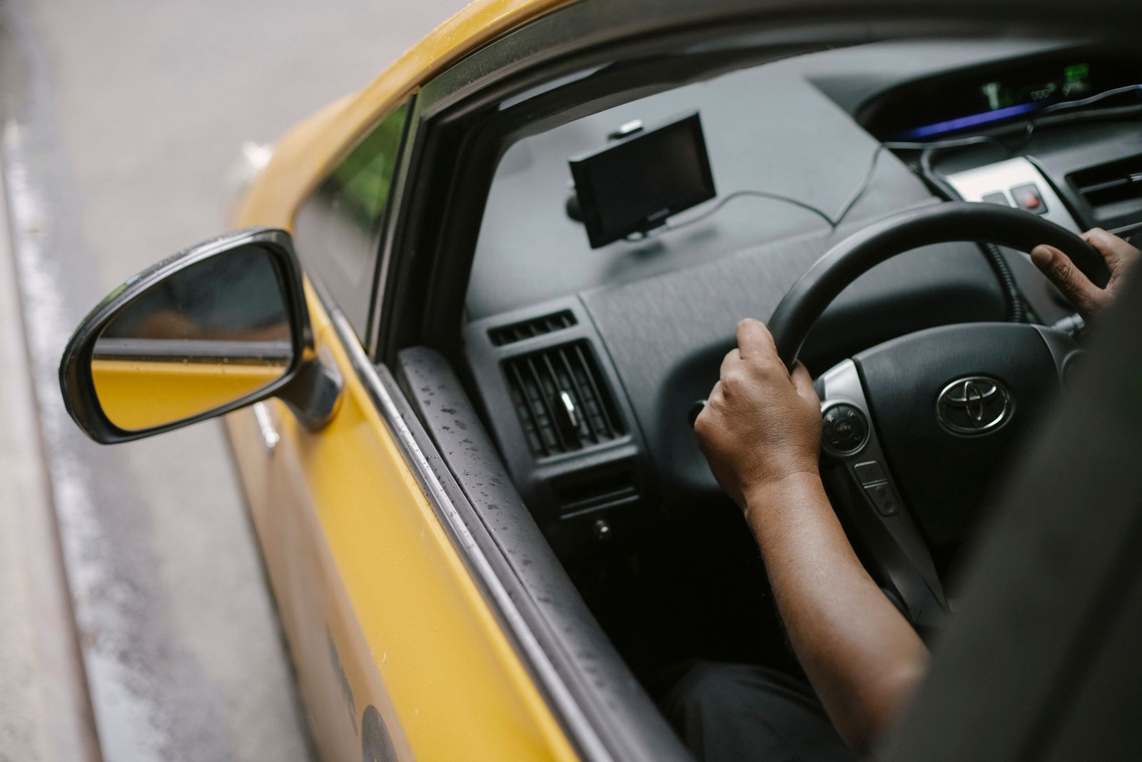 A taxi driver using navigation on a city street