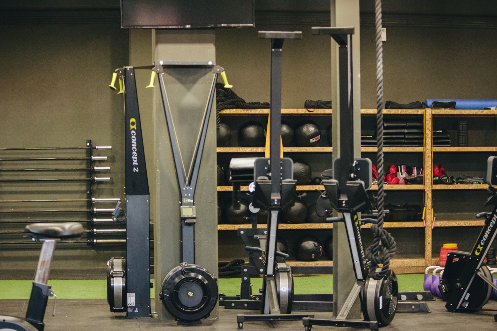 The floor of a fitness club, machines lined up under daylight