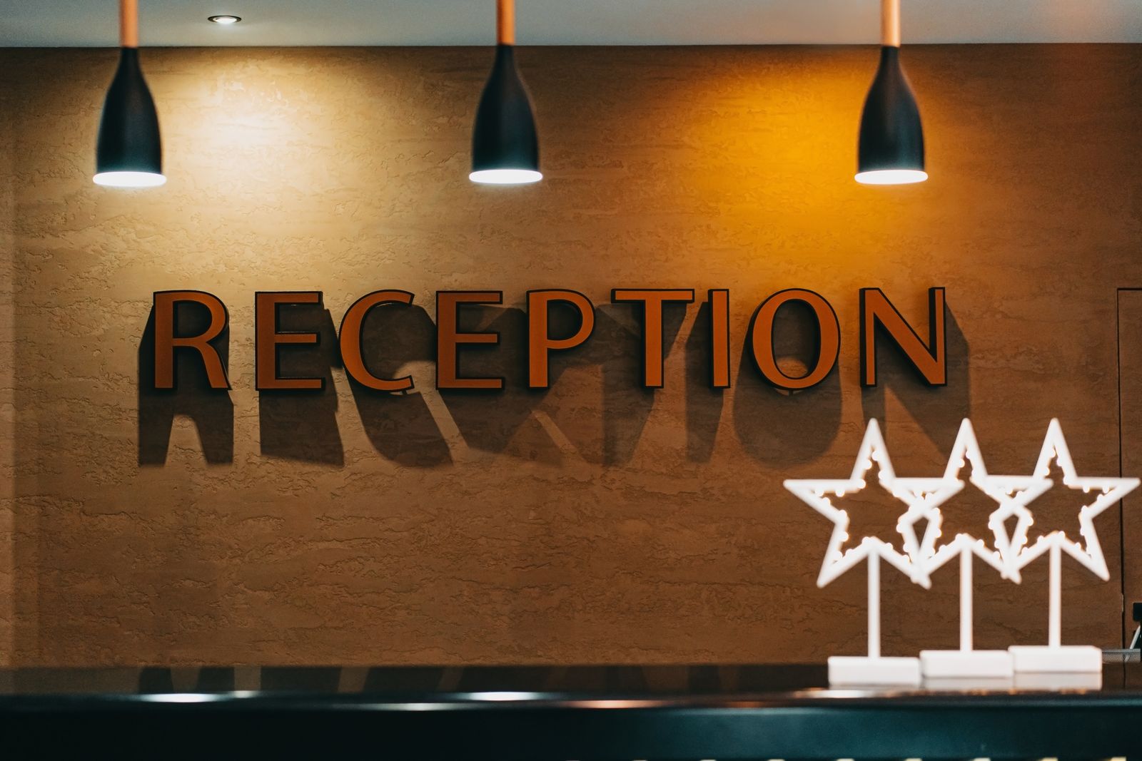 A hotel reception desk, lit and empty