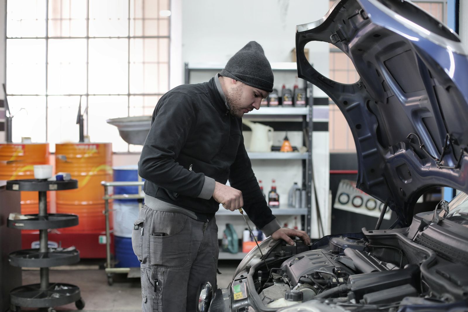 A mechanic working on an engine in a garage