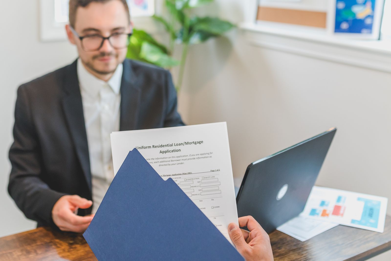 A broker and client going through a loan application