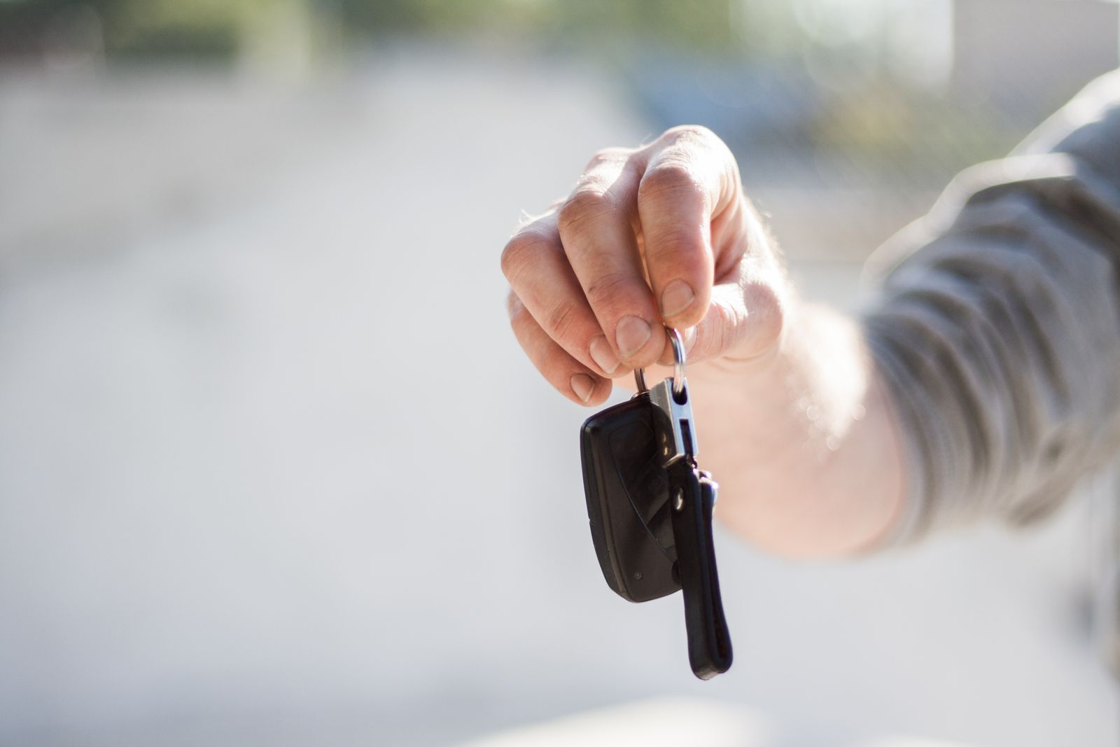 Car keys being handed across a rental counter