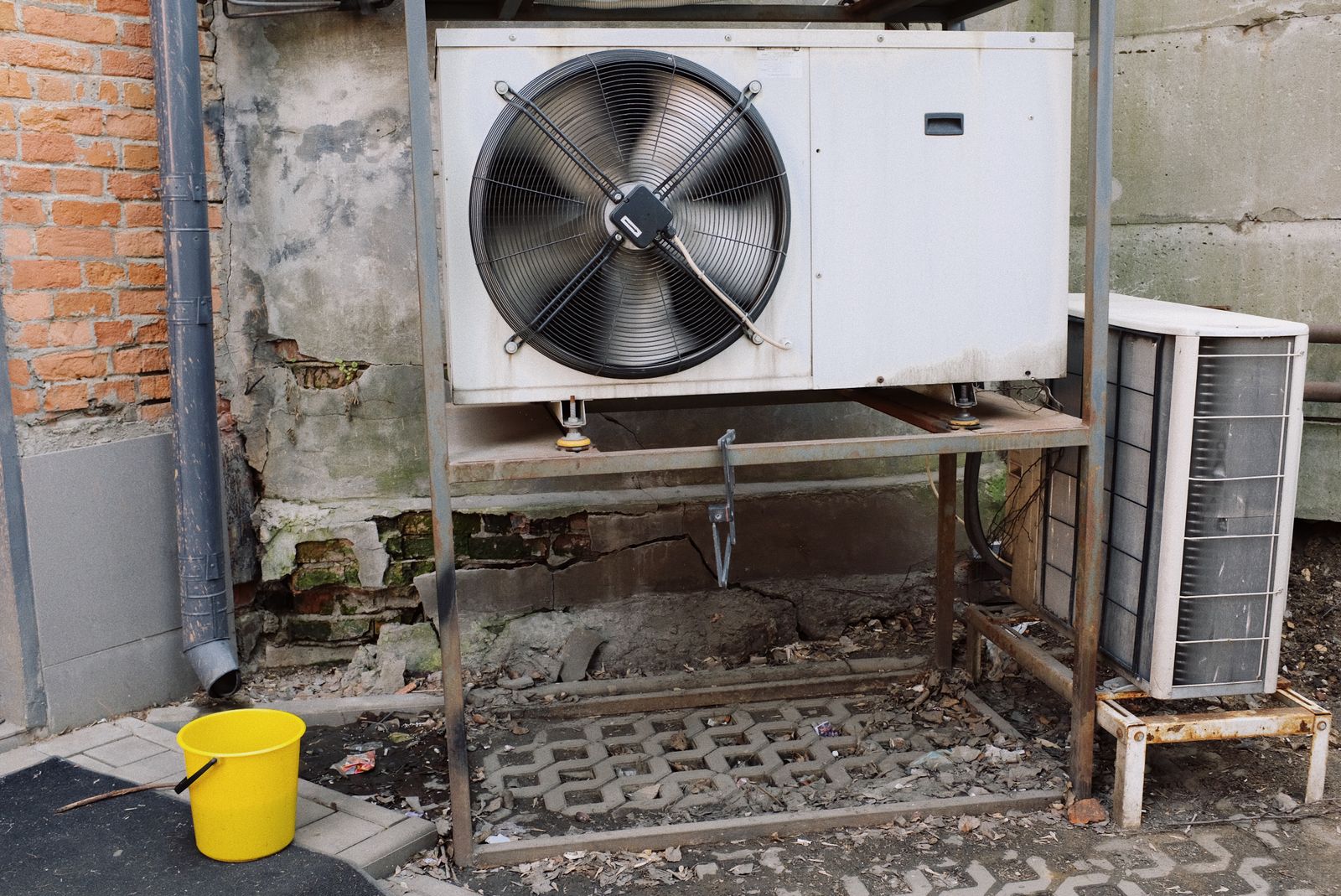 A technician servicing an air-conditioning unit