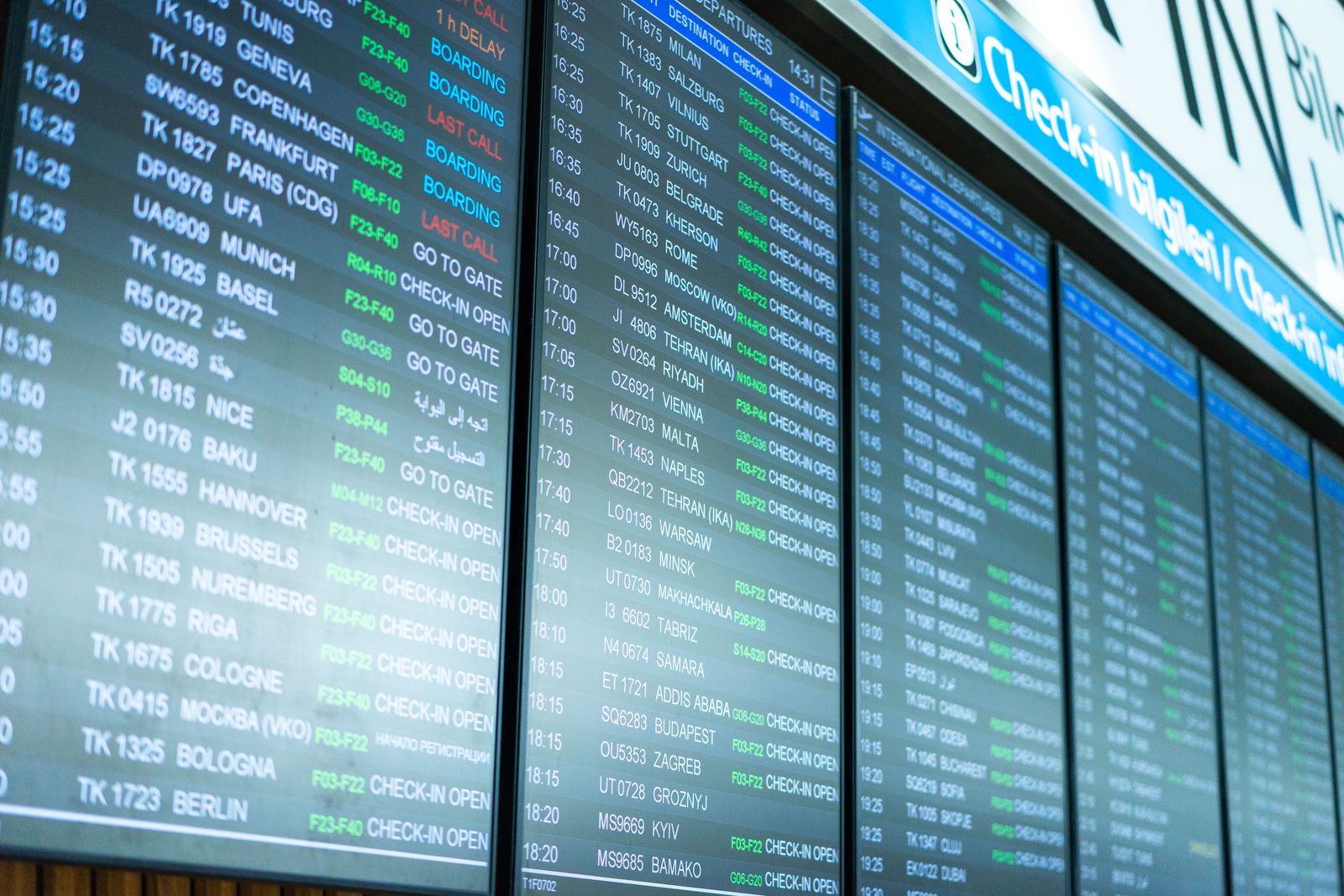 A departure board listing flights in an airport terminal