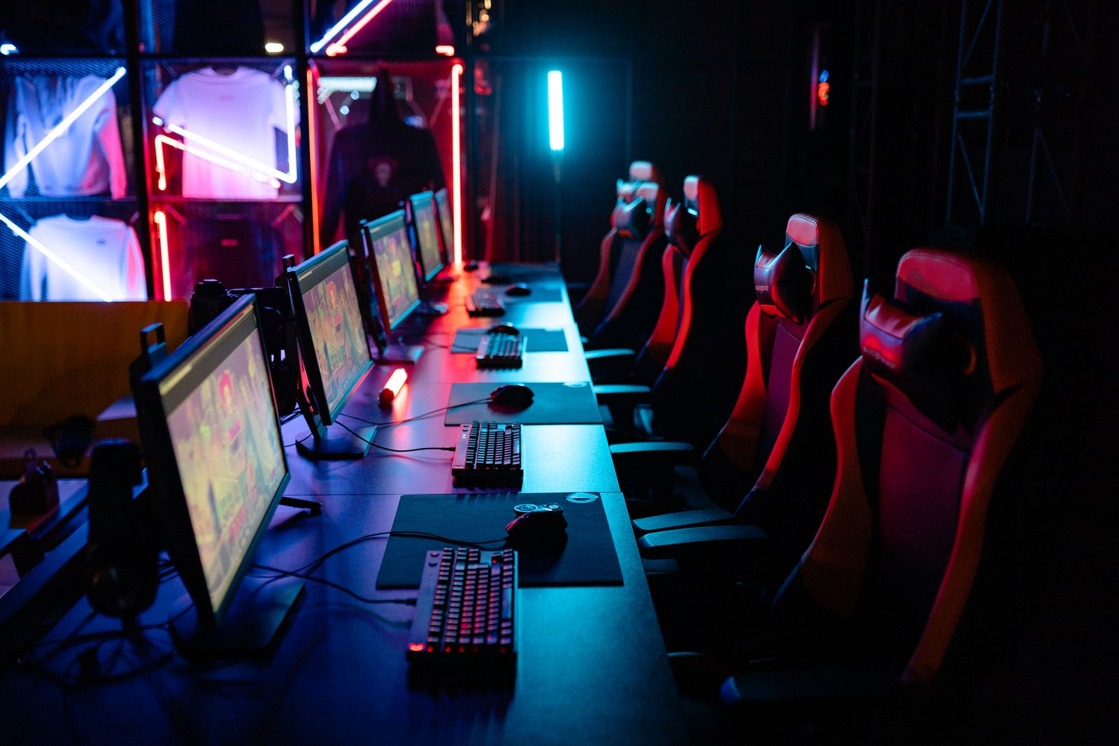 A gaming setup with lit machines and chairs