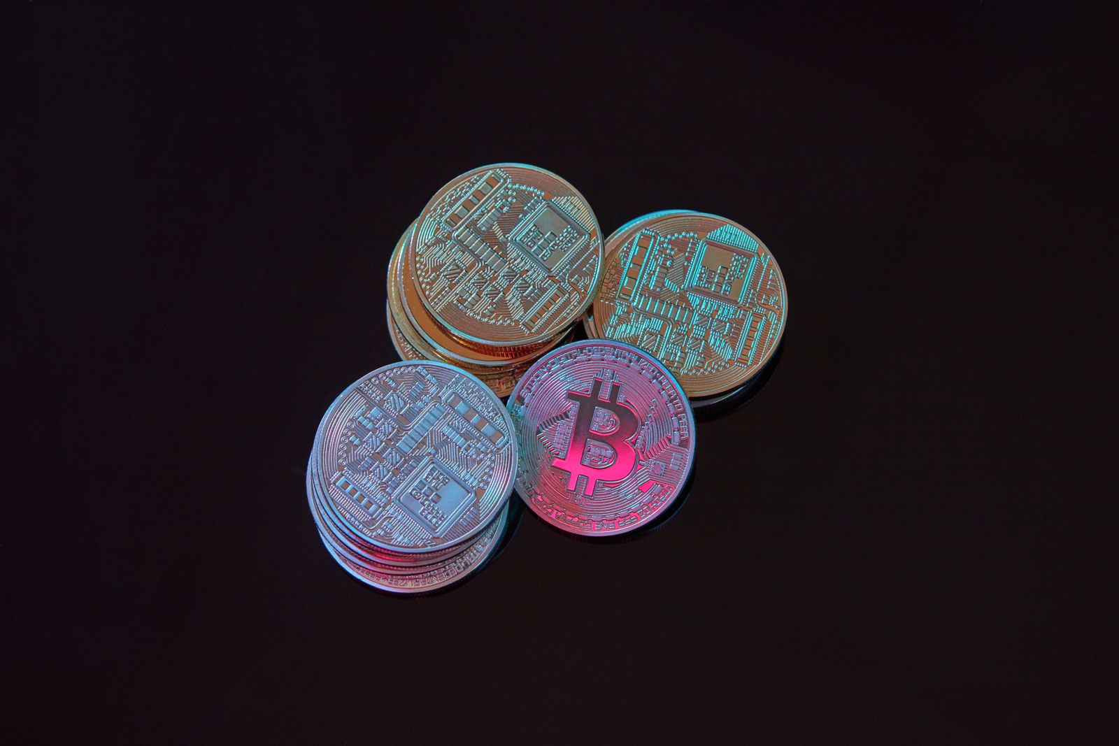 Cryptocurrency coins stacked on a dark surface
