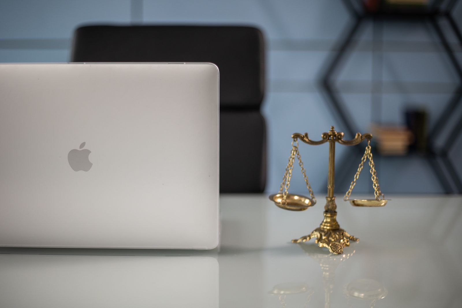 A law office desk with case files and bound volumes behind it