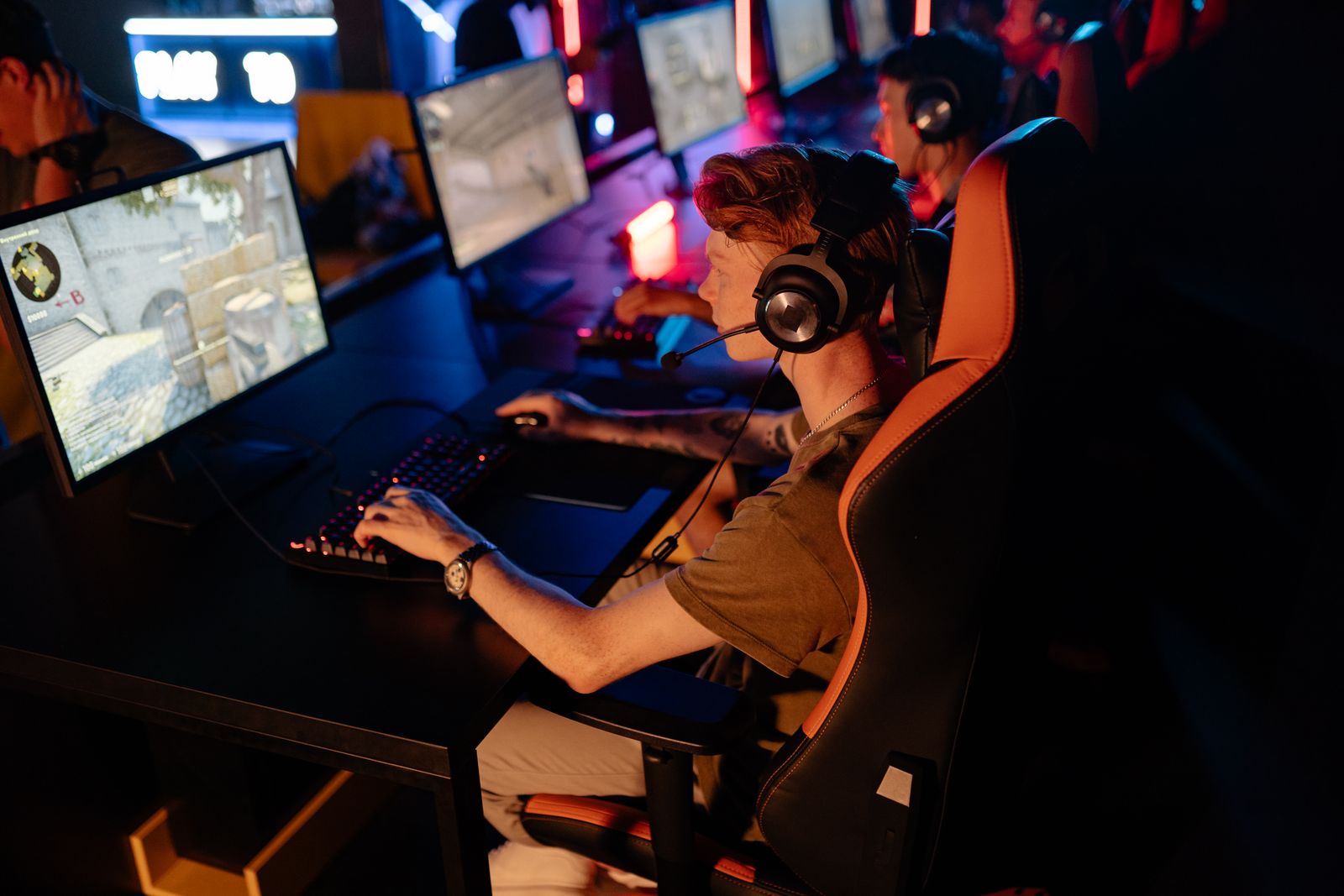 Players at a row of machines in an esports arena