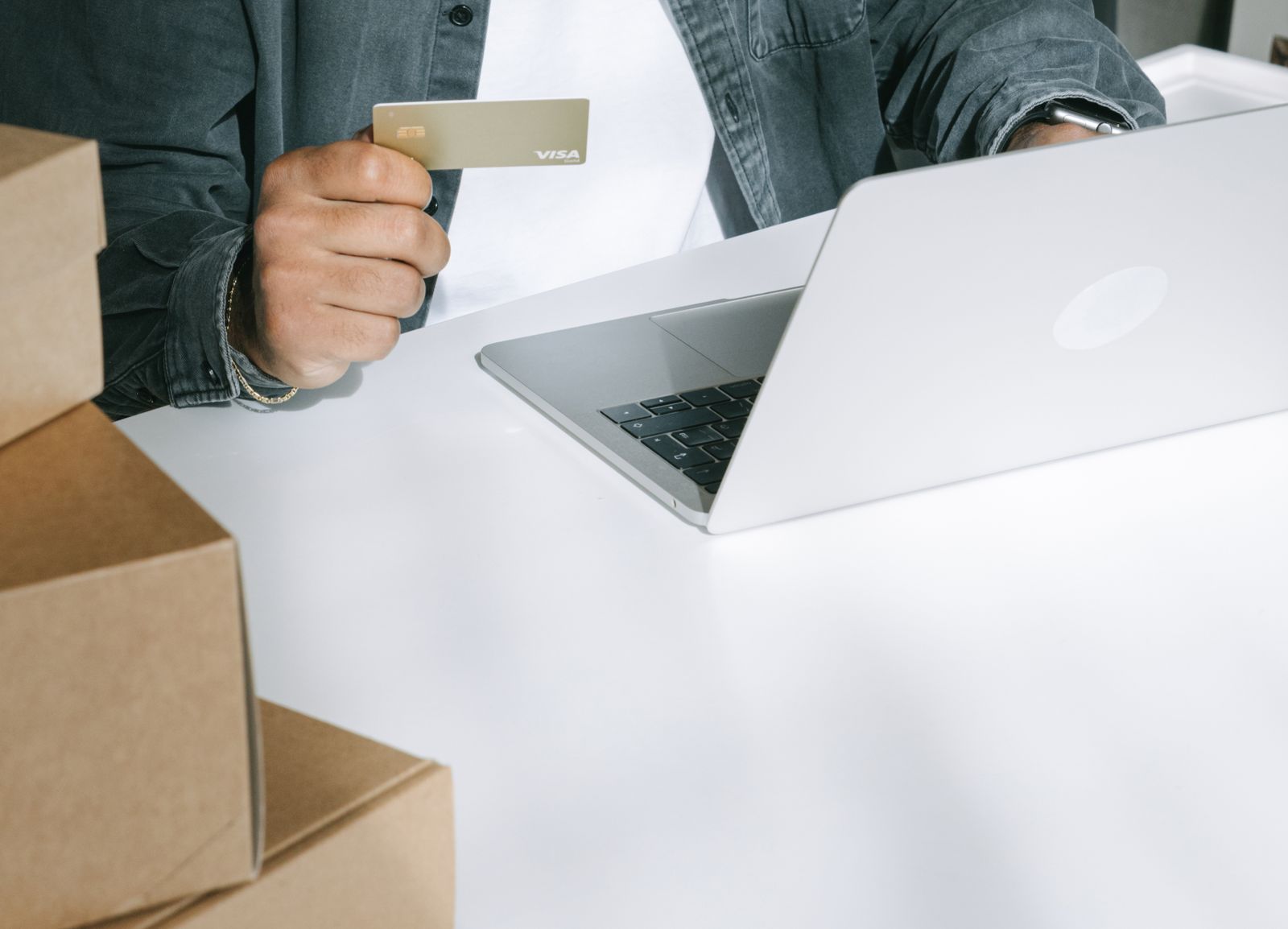 Someone paying by card on a laptop